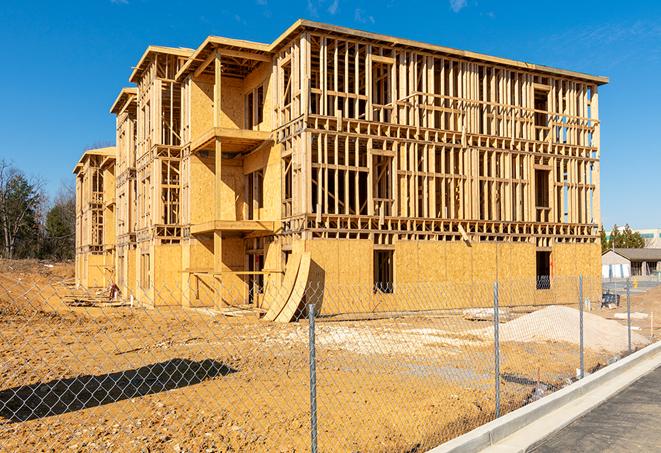 a close-up of temporary chain link fences enclosing a job site, signaling progress in the project's development in Indialantic